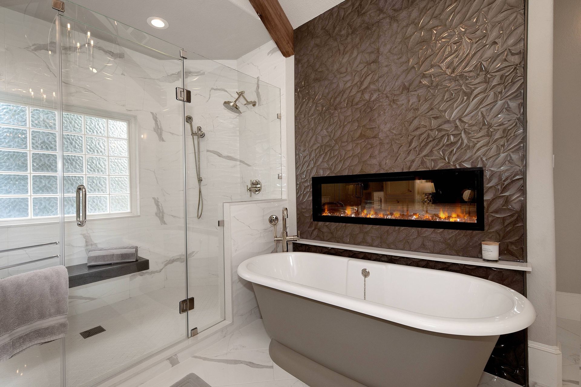 A bathroom with a tub , shower and fireplace.