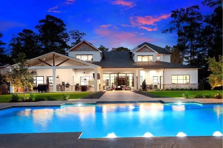 A large house with a swimming pool in front of it