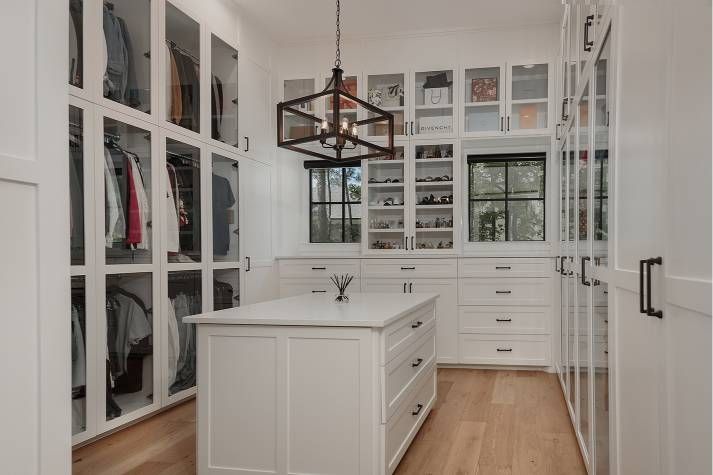 There is a large island in the middle of the walk in closet.