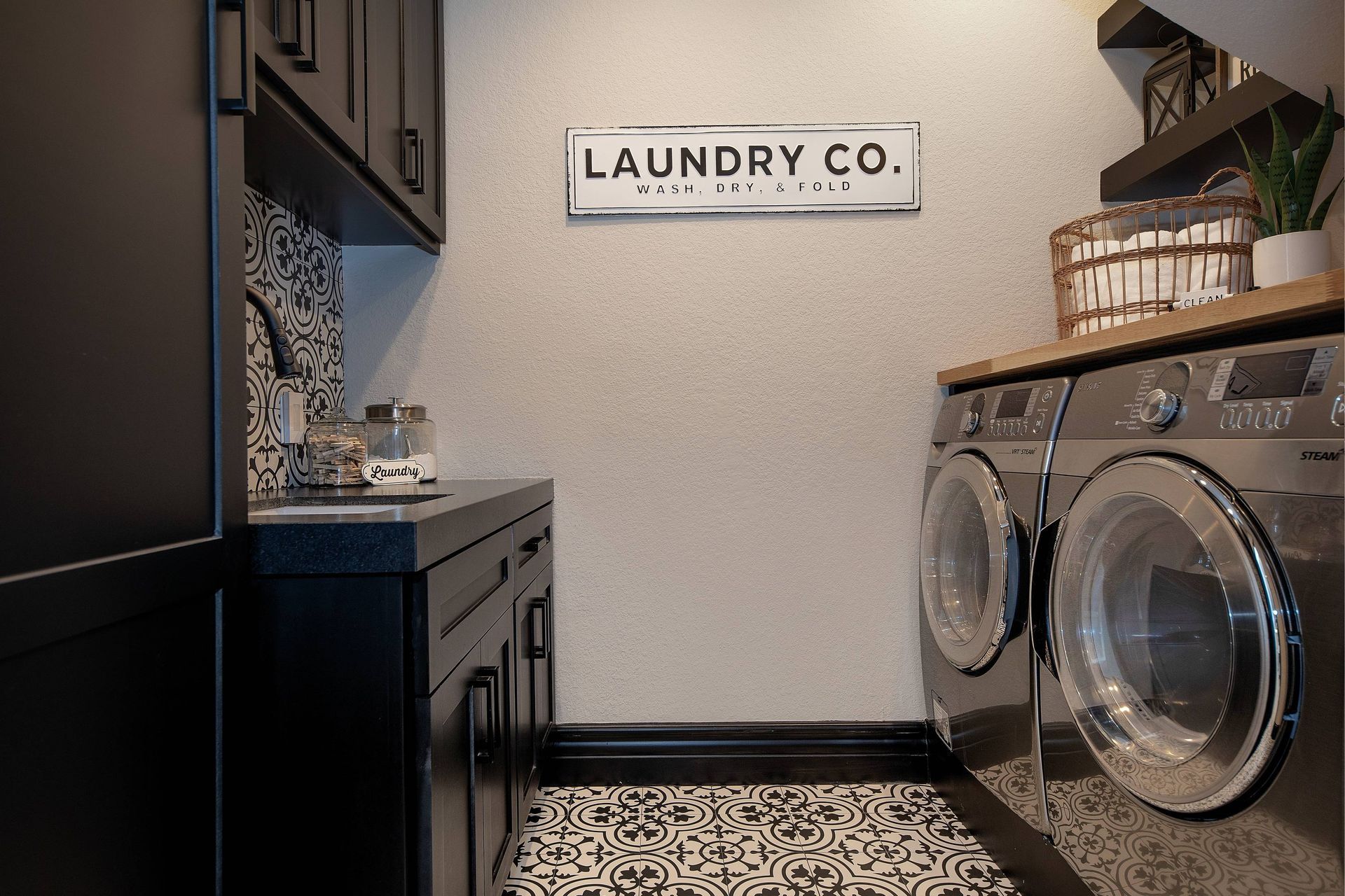 A laundry room with a sign on the wall that says laundry co.