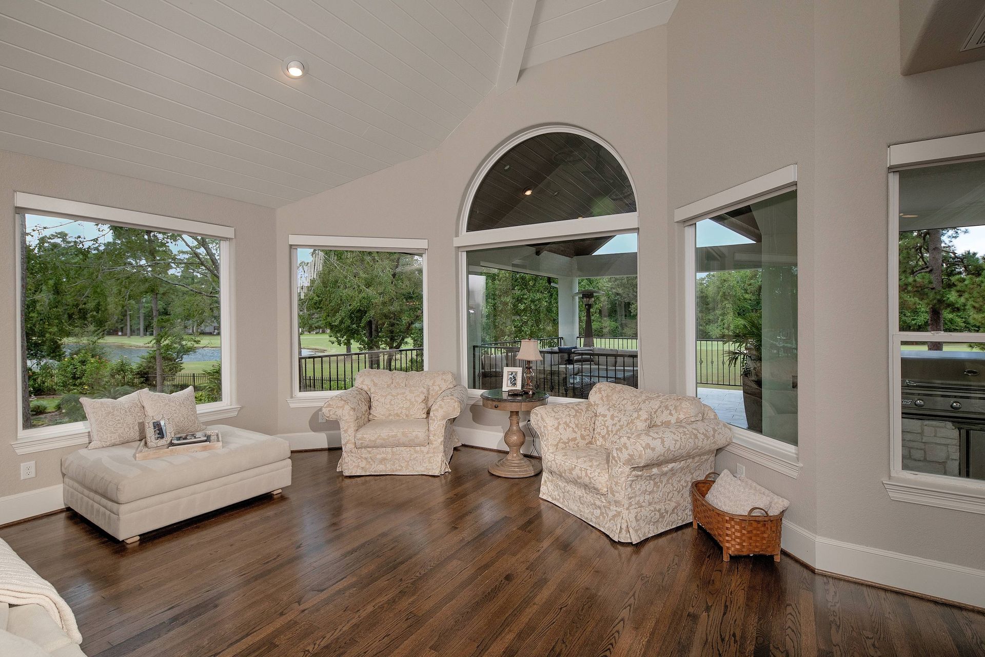 A living room with a lot of windows and furniture