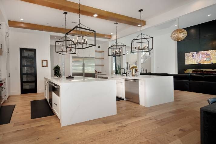 A large kitchen with two islands and stainless steel appliances.