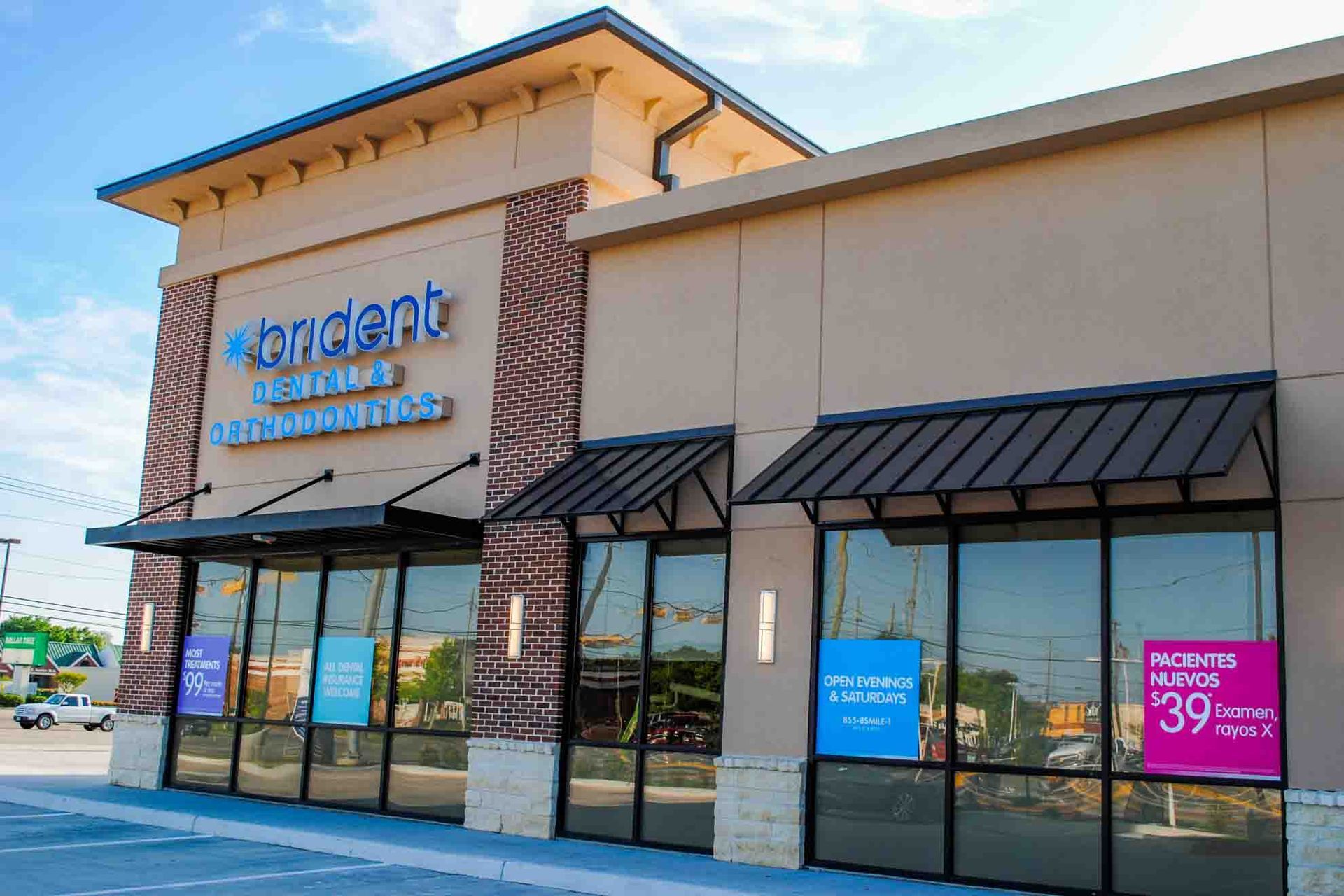 A dental office with a lot of windows and a canopy.