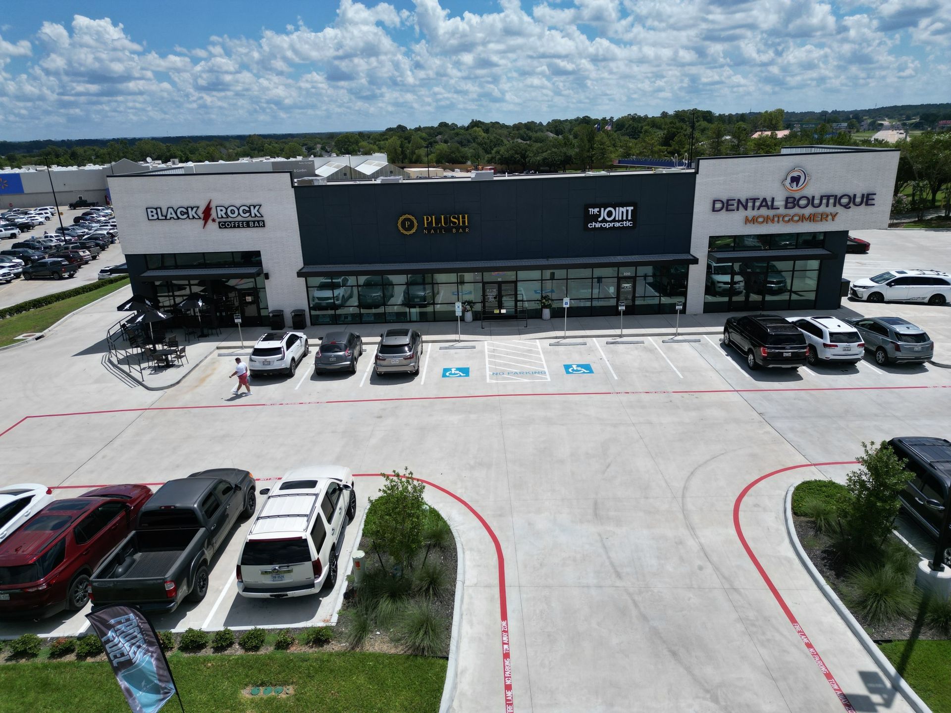 An aerial view of a parking lot in front of a dental boutique
