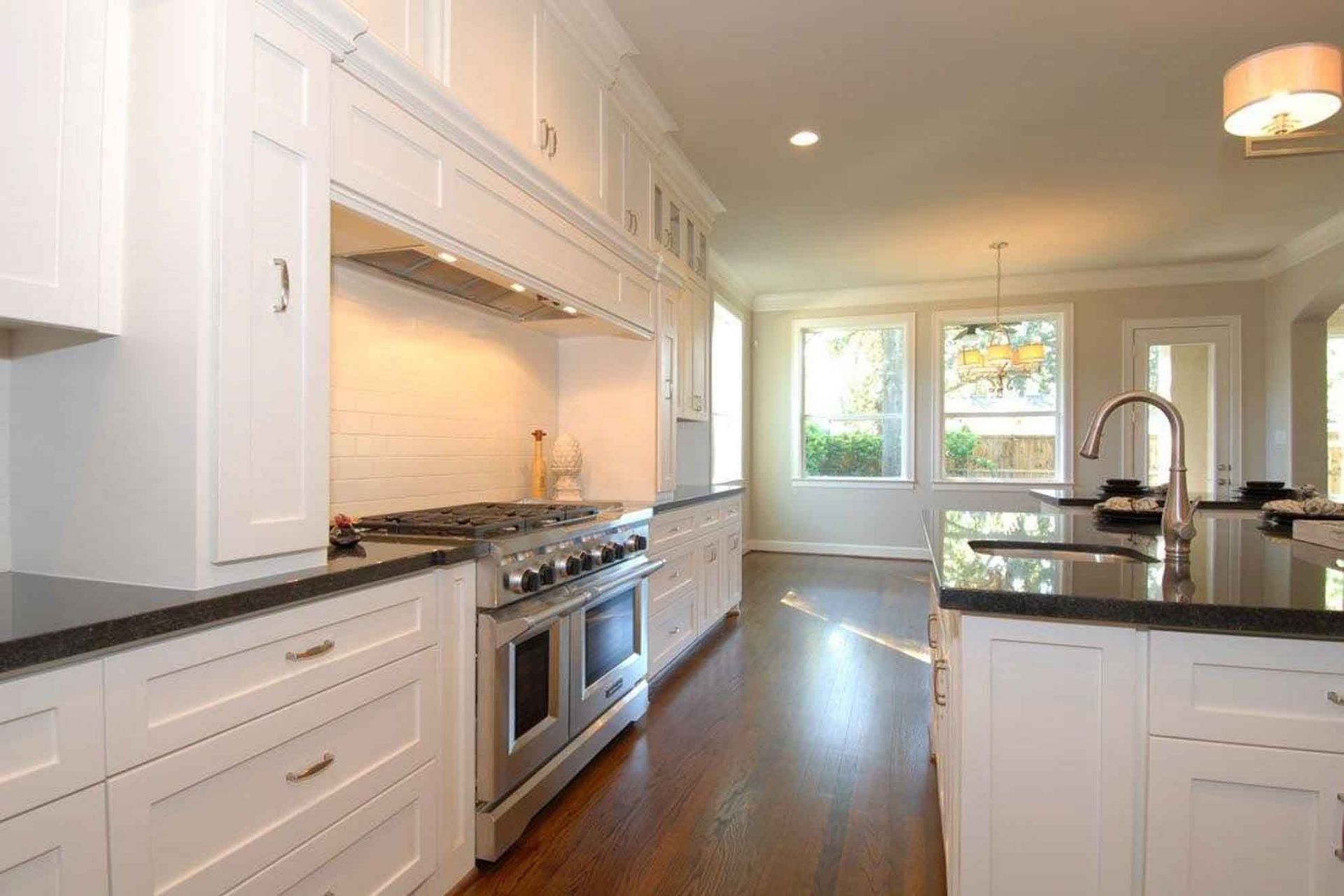 A kitchen with white cabinets and stainless steel appliances.