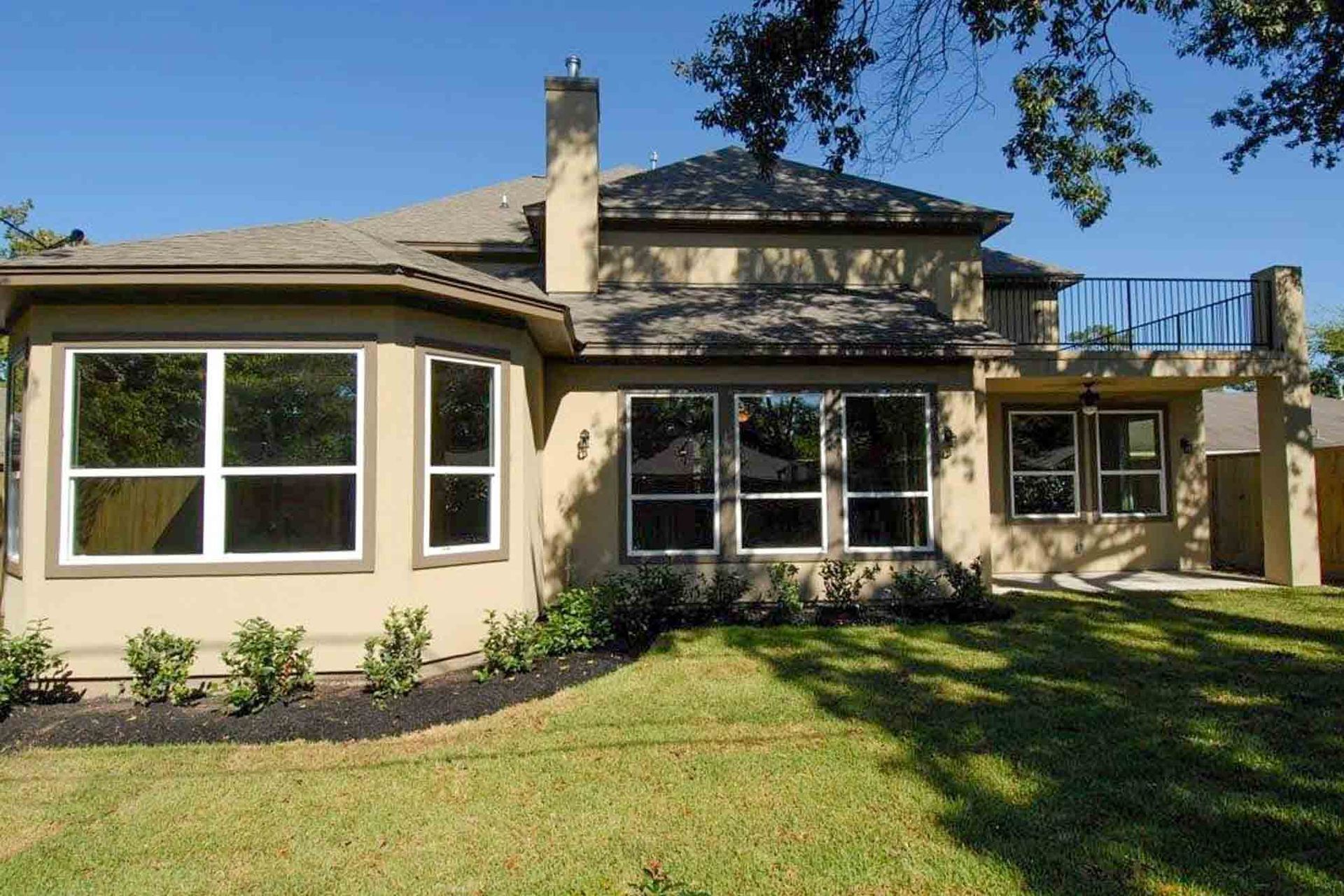 A large house with a lot of windows and a balcony