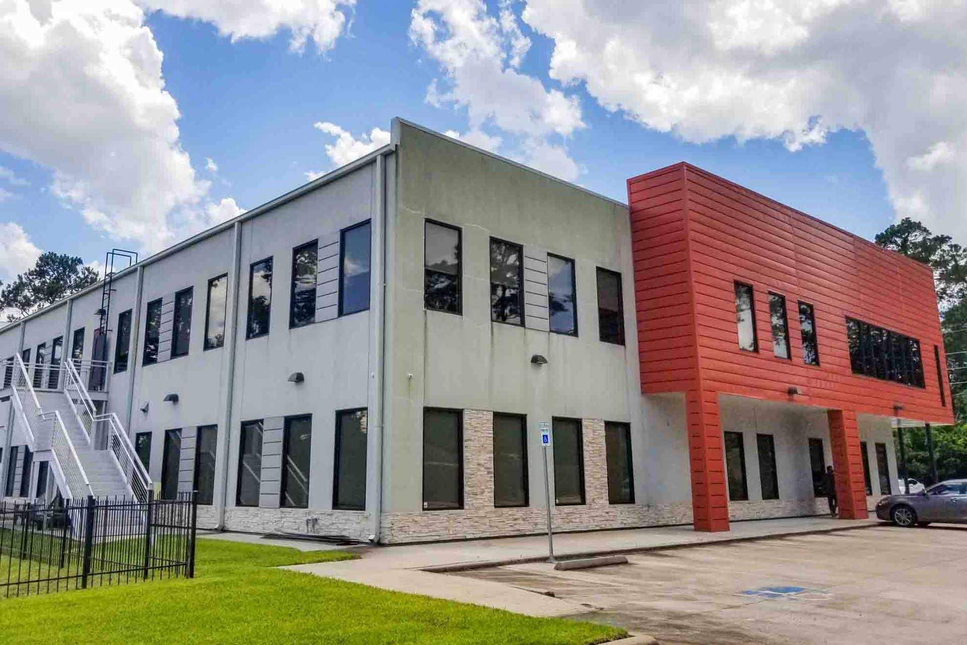 A large white and red building with a fire escape.