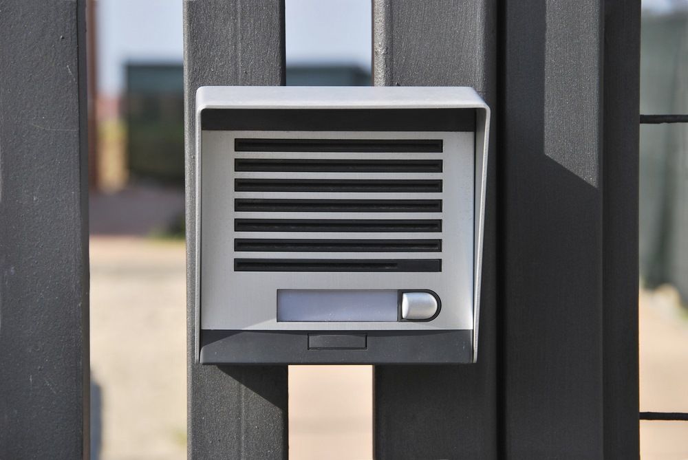 A Doorbell Is Sitting on Top of A Metal Fence — MNC Security in Boambee, NSW
