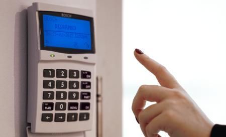 A Person Pressing a Button on A Security System — MNC Security in Korora, NSW