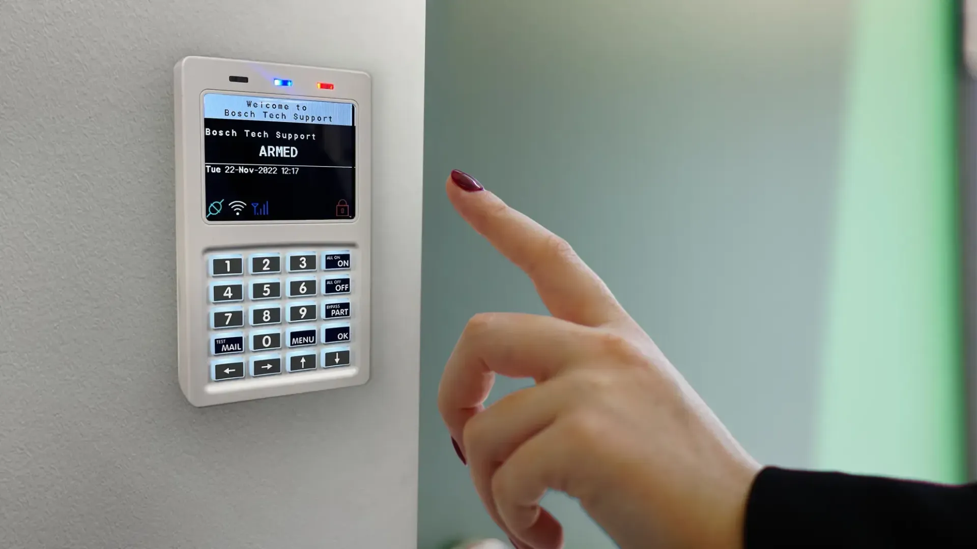 Person using a Bosch security alarm keypad. — MNC Security in Sawtell, NSW
