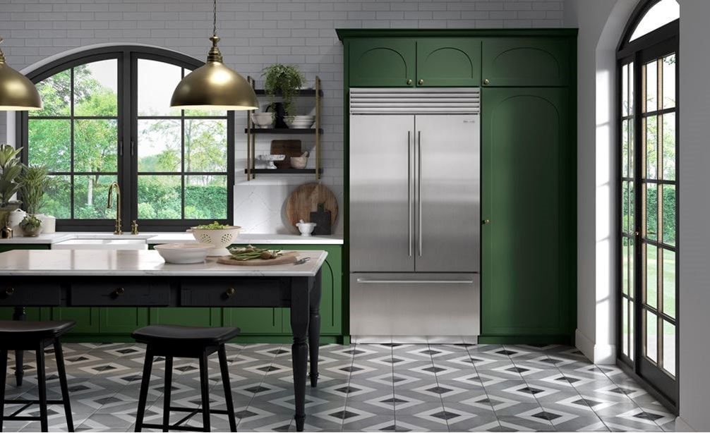 A man is fixing an oven in a kitchen.