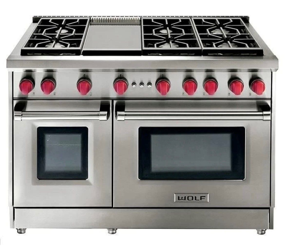 A man is fixing an oven in a kitchen.