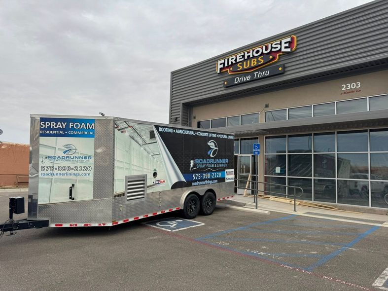 A trailer is parked in front of a building.