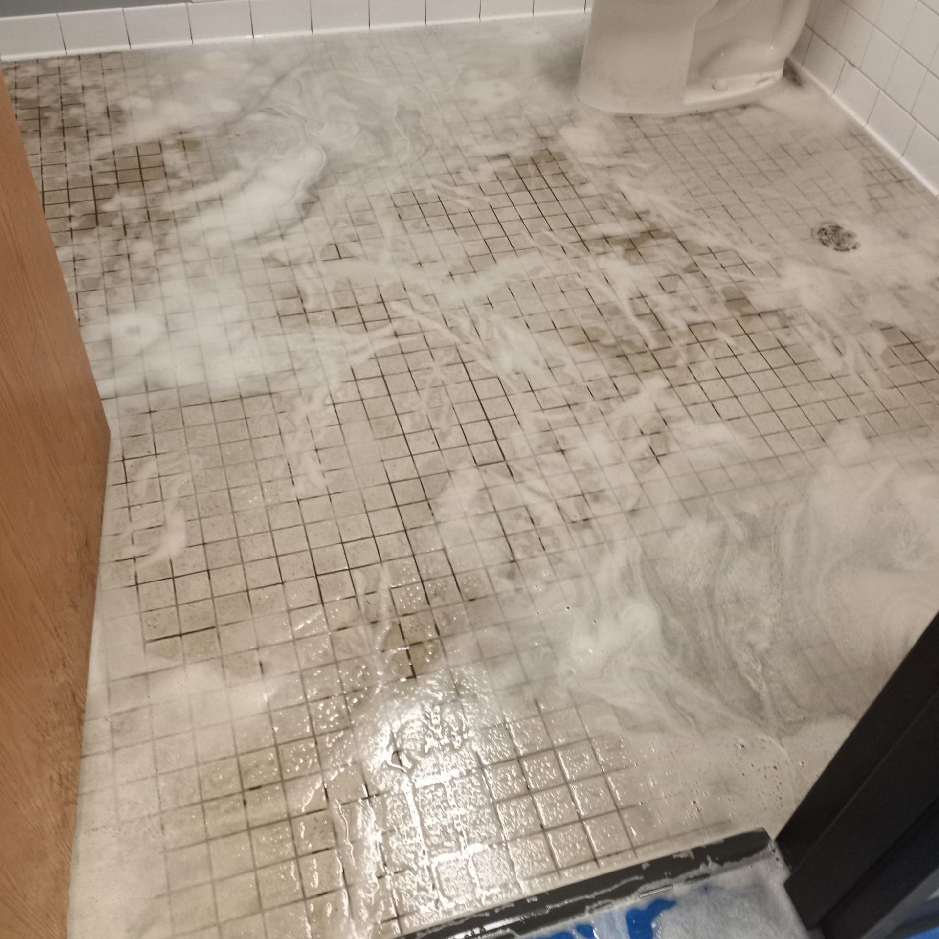 A bathroom floor with a lot of foam on it