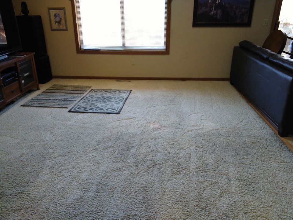 A living room with a rug on the floor