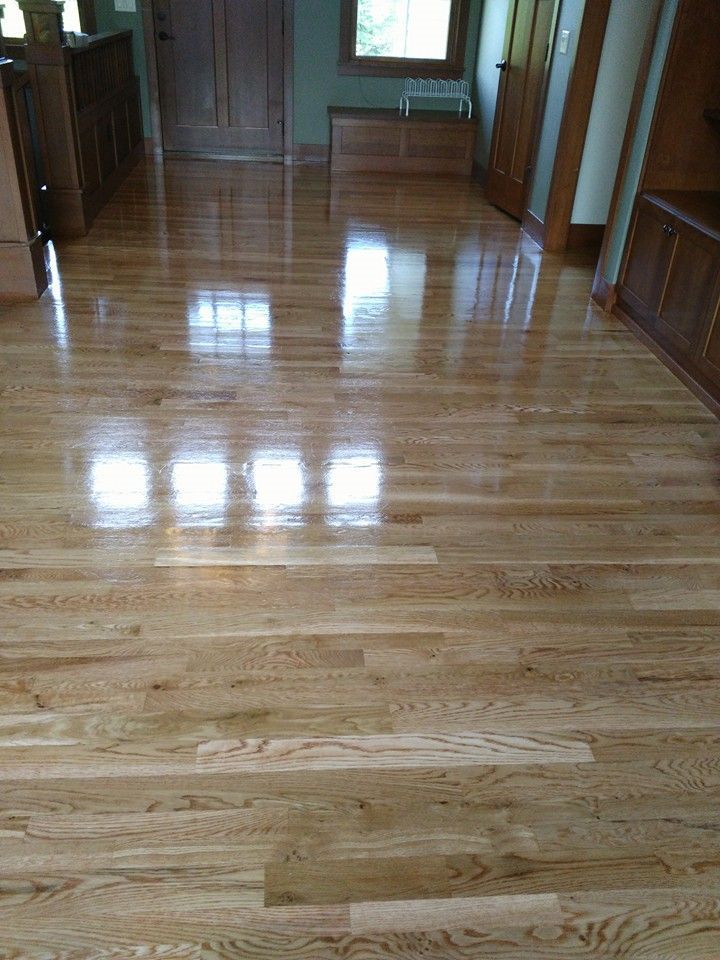 A living room with a wooden floor and a window.