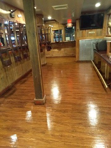 There is a wooden floor in the middle of a room.