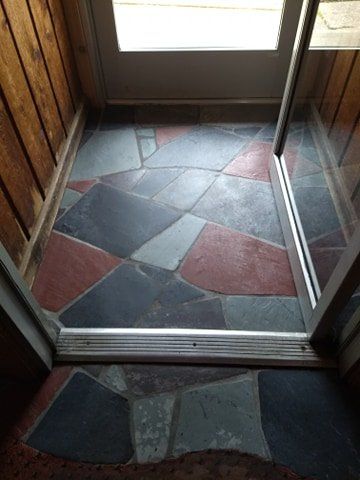 A doorway with a tiled floor and a sliding glass door