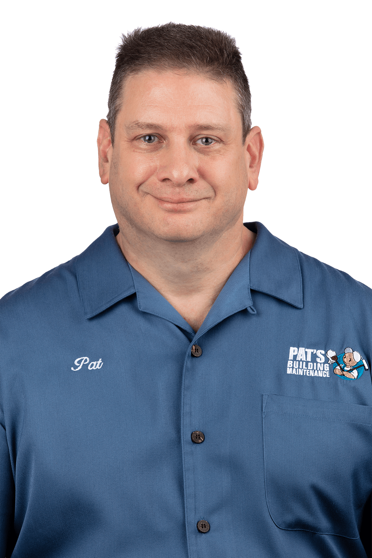A man in a blue shirt is smiling for the camera.