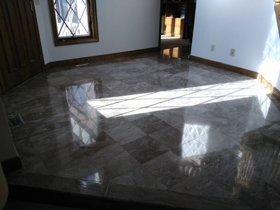 A room with a marble floor and a window.