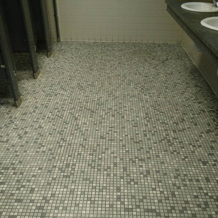 A bathroom with two sinks and a tiled floor.