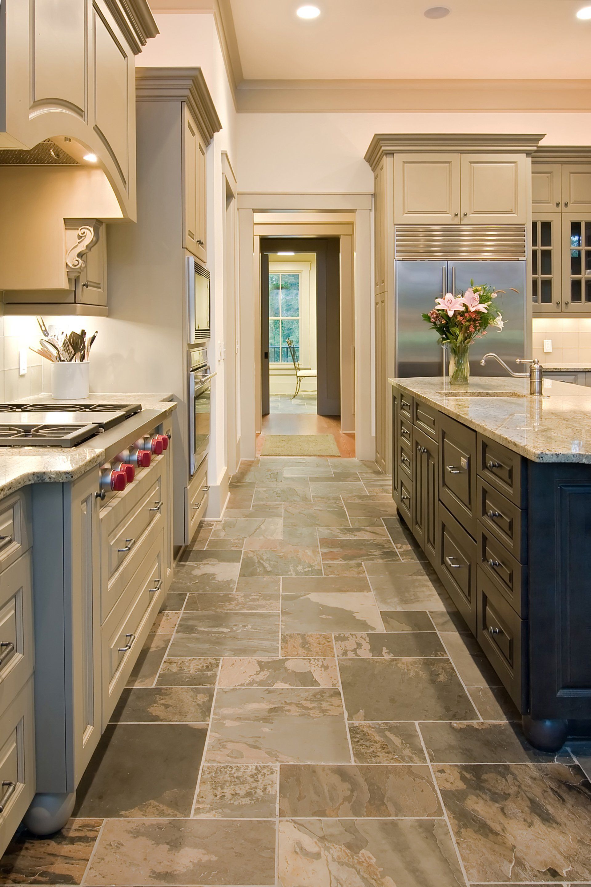 A kitchen with a tiled floor and a stove top oven