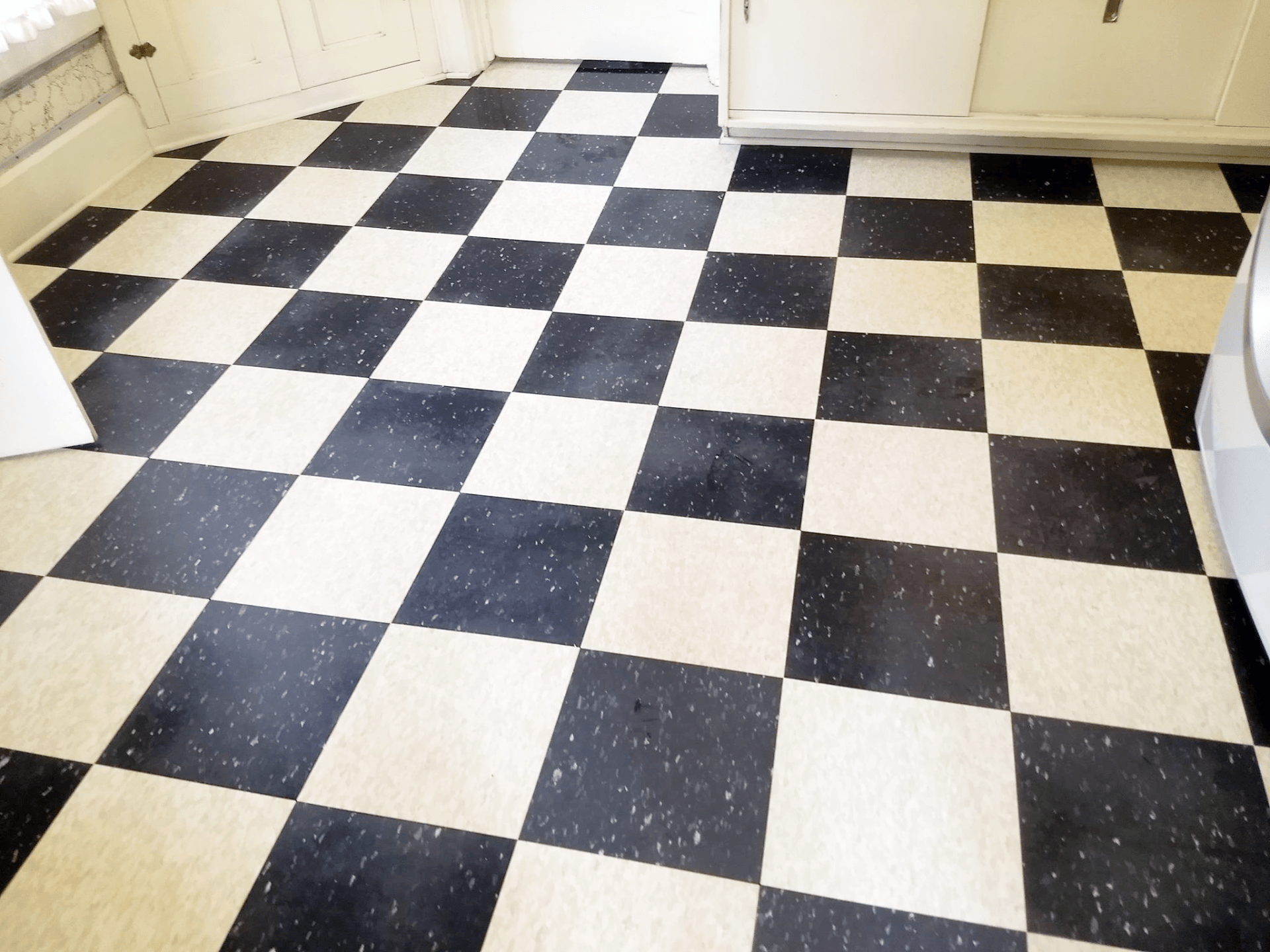 A black and white checkered floor in a kitchen