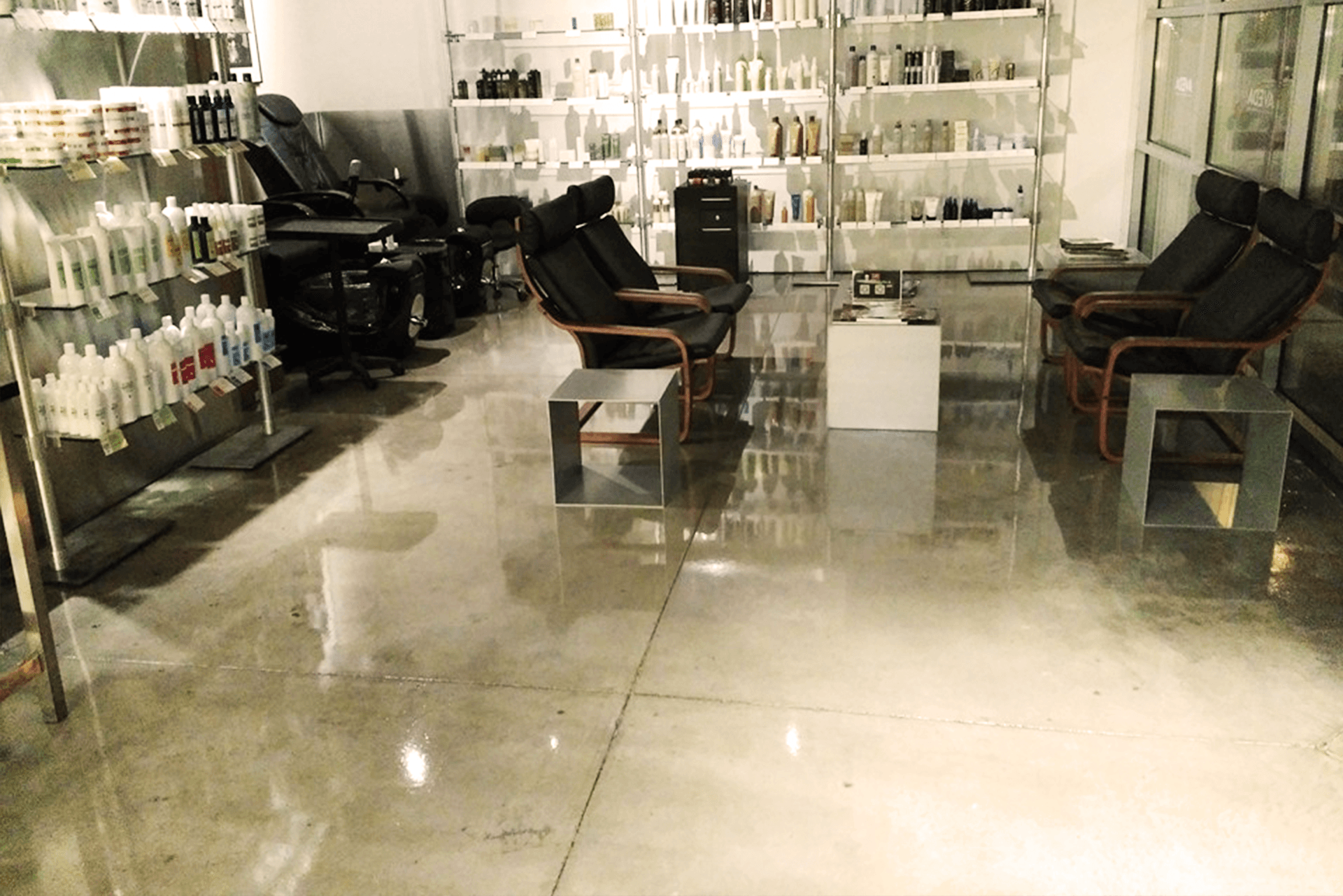 A salon with chairs and shelves full of hair products