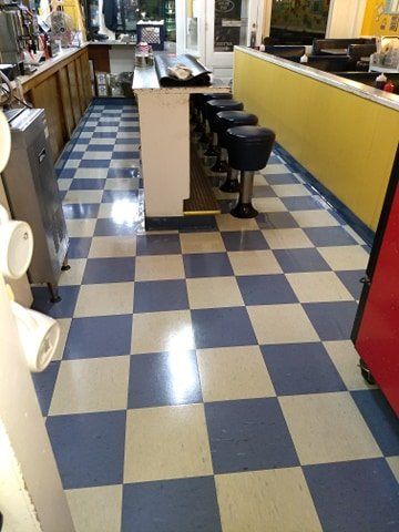 A restaurant with a checkered floor and stools