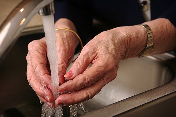 Senior Woman Washing Her Hands — Sanford, FL — Hancock Plumbing Co Inc