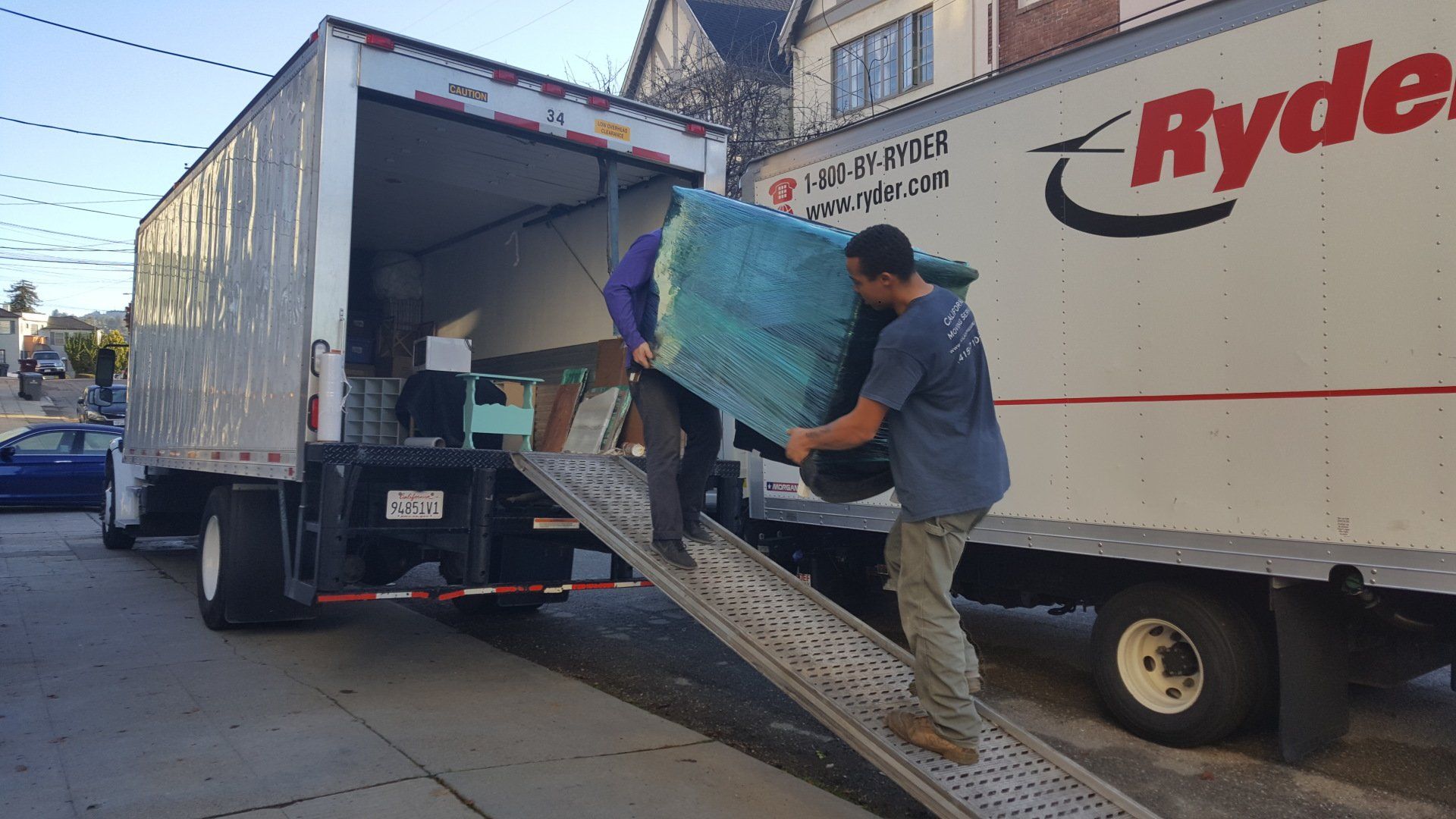 Movers Lifting Furniture Into Truck