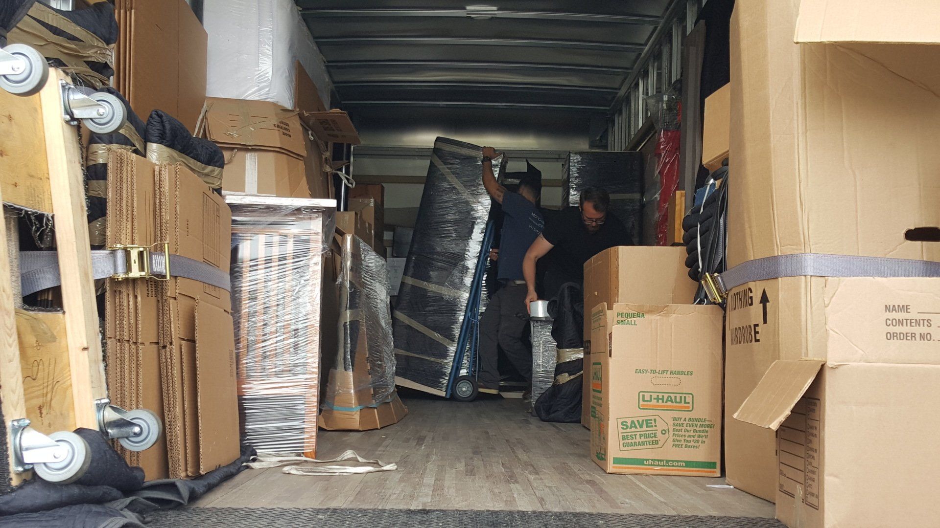 Long-distance movers packing a truck