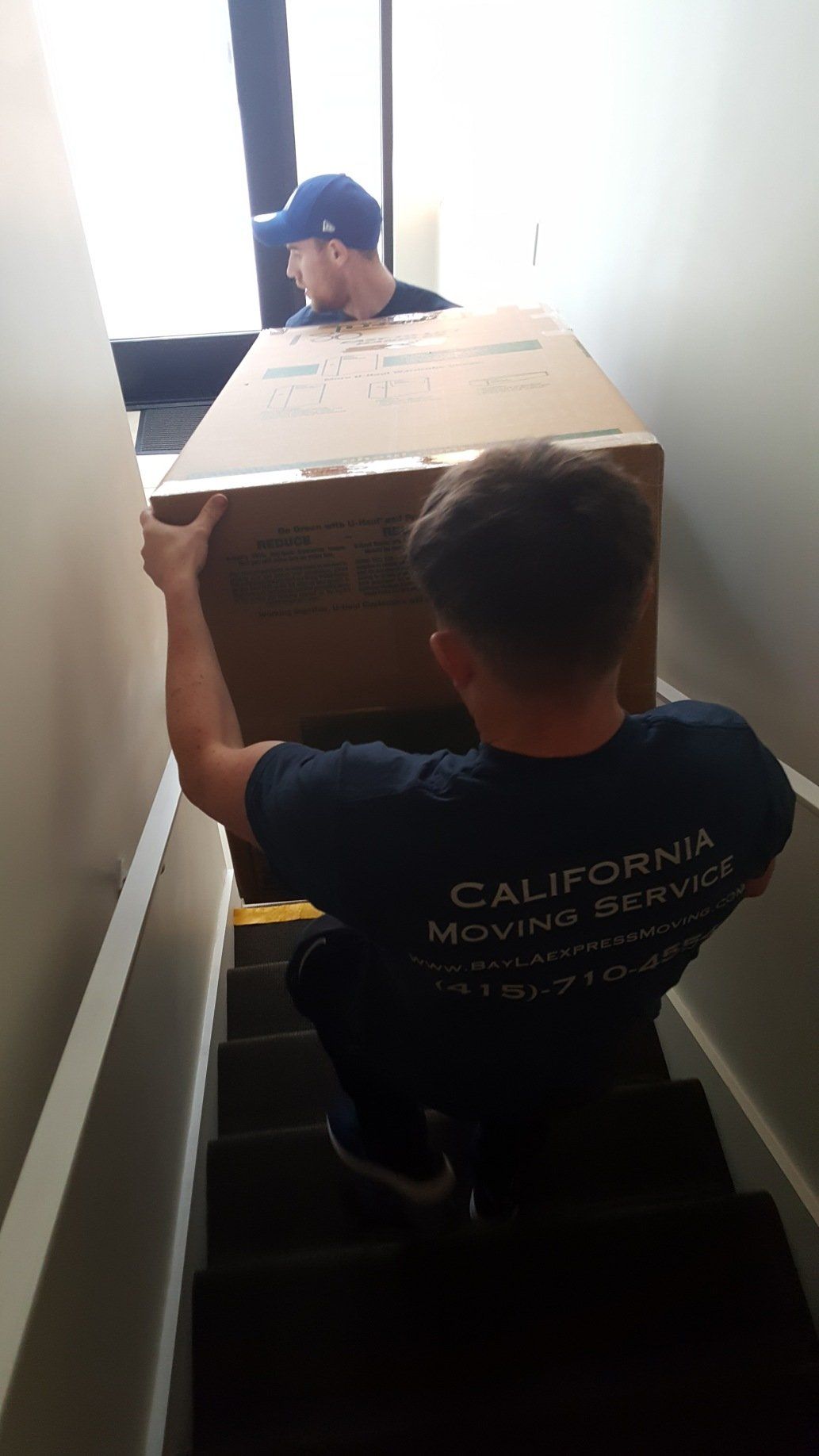 Long-Distance Movers Lifting Large Box