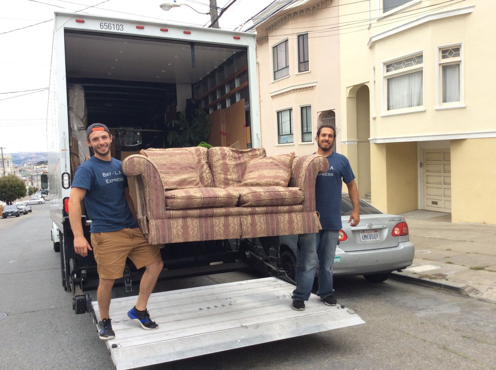 Movers unloading a couch