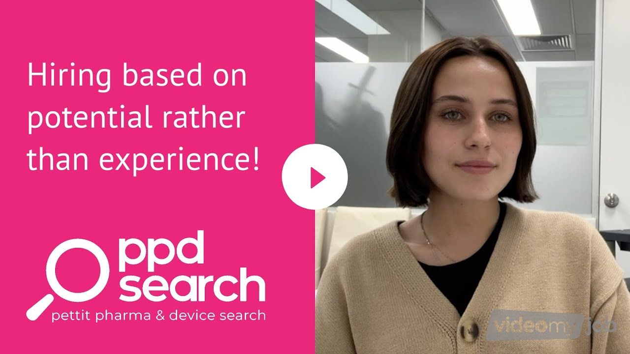 Woman in beige sweater promoting 