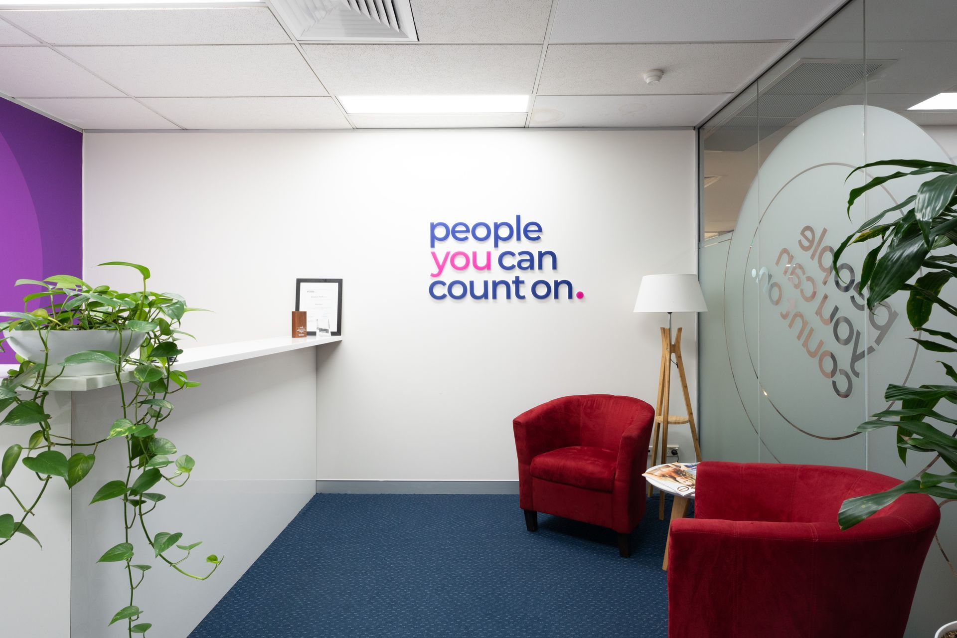 Two white square logos on a purple background. 