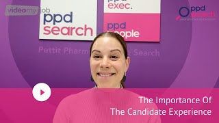 Woman in pink top discusses candidate experience in front of a pink and white sign that reads 