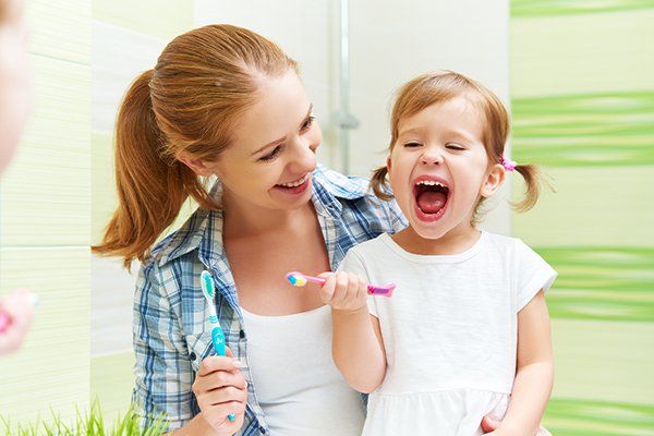 Mother And Kid Brushing Teeth — Bristol, TN — McMillin & Christian Family Dentistry