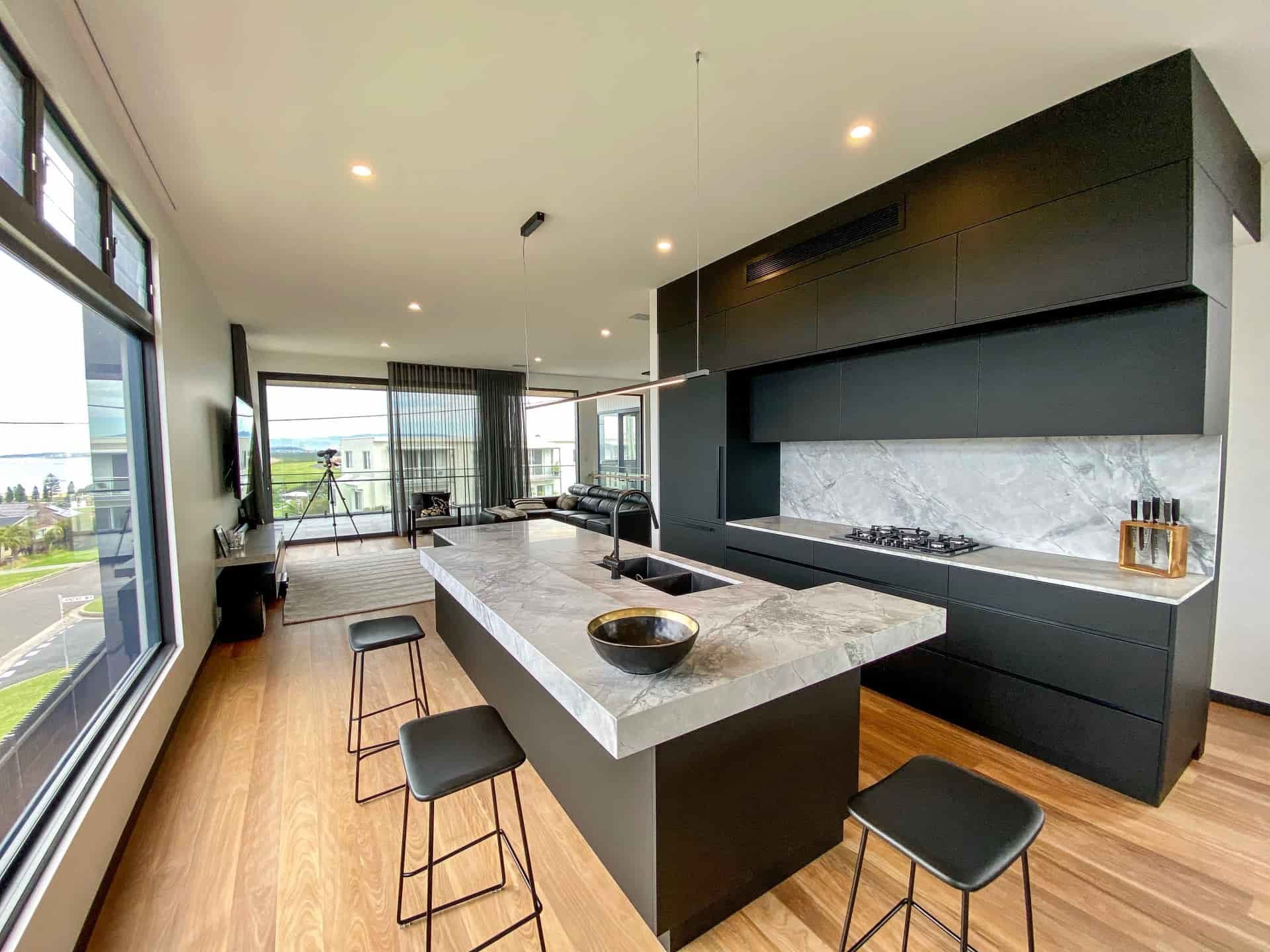 Bathroom With Round Mirror, Copper Pipes, Concrete Counter — Envisage Construction and Design in Ulladulla, NSW