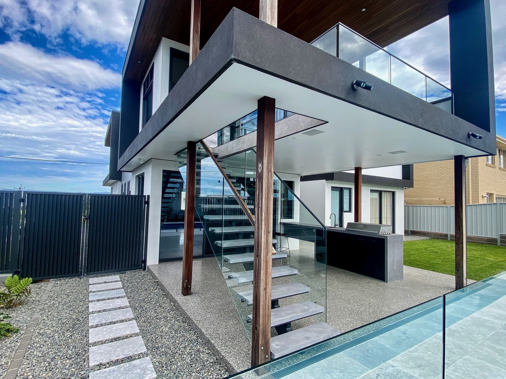 Modern Two-story House With Glass Railings — Envisage Construction and Design in Anzac Way, NSW

