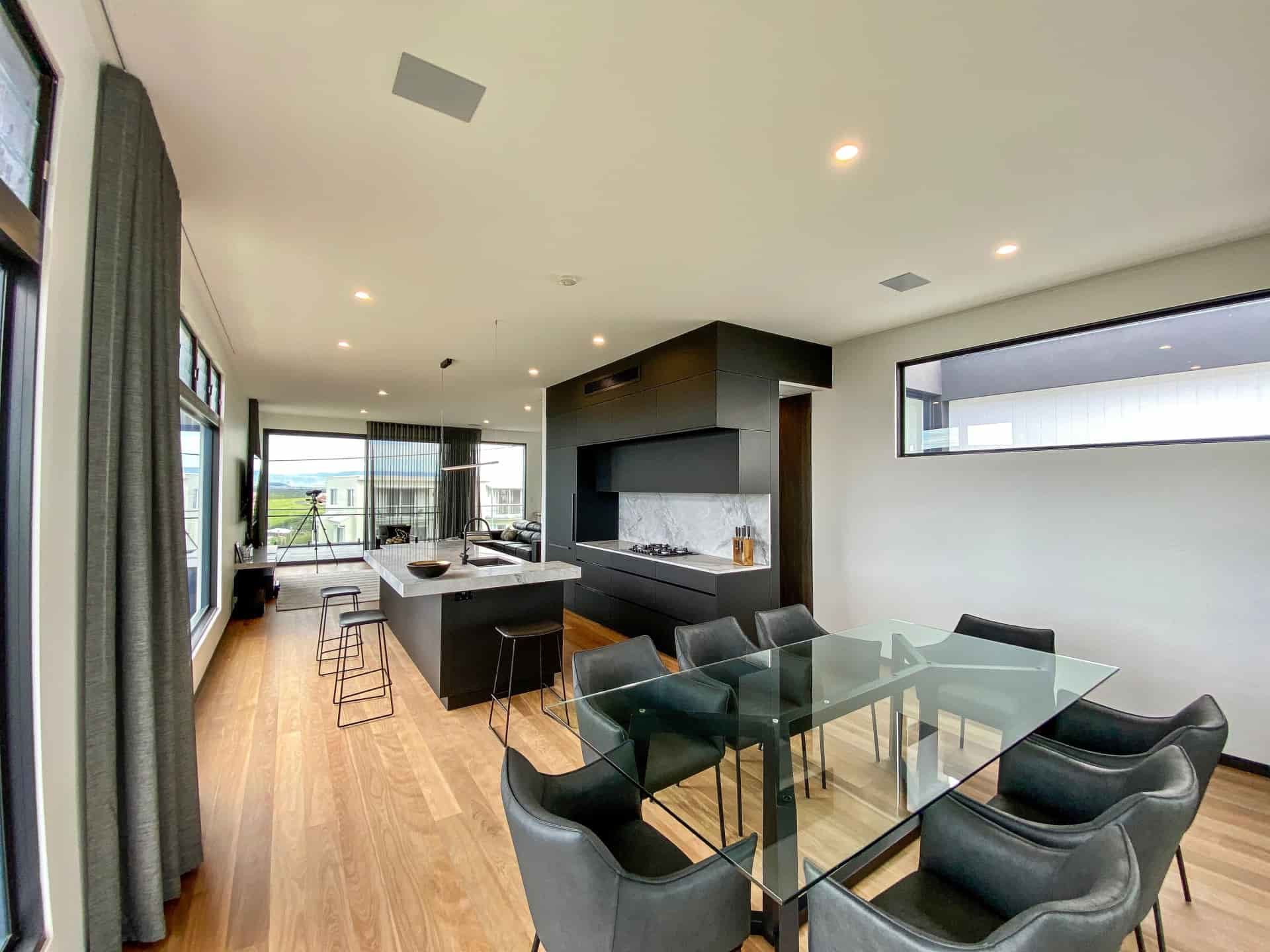 Modern Kitchen and Dining Area With Dark Cabinets — Envisage Construction and Design in Anzac Way, NSW
