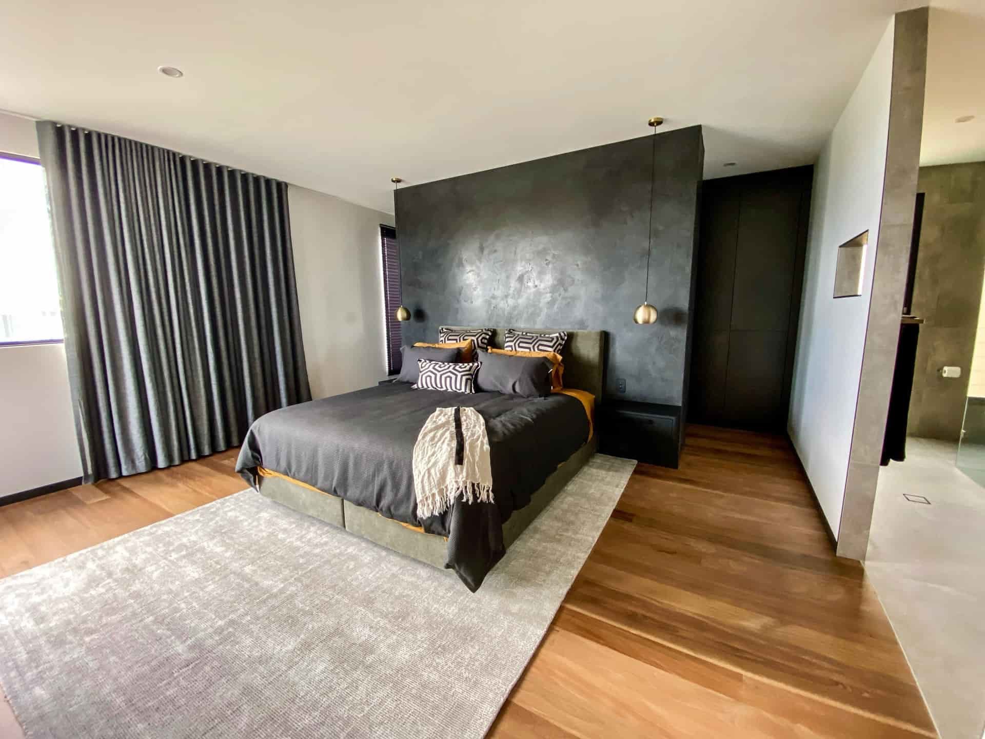 Dark Bedroom With Textured Black Accent Wall — Envisage Construction and Design in Anzac Way, NSW

