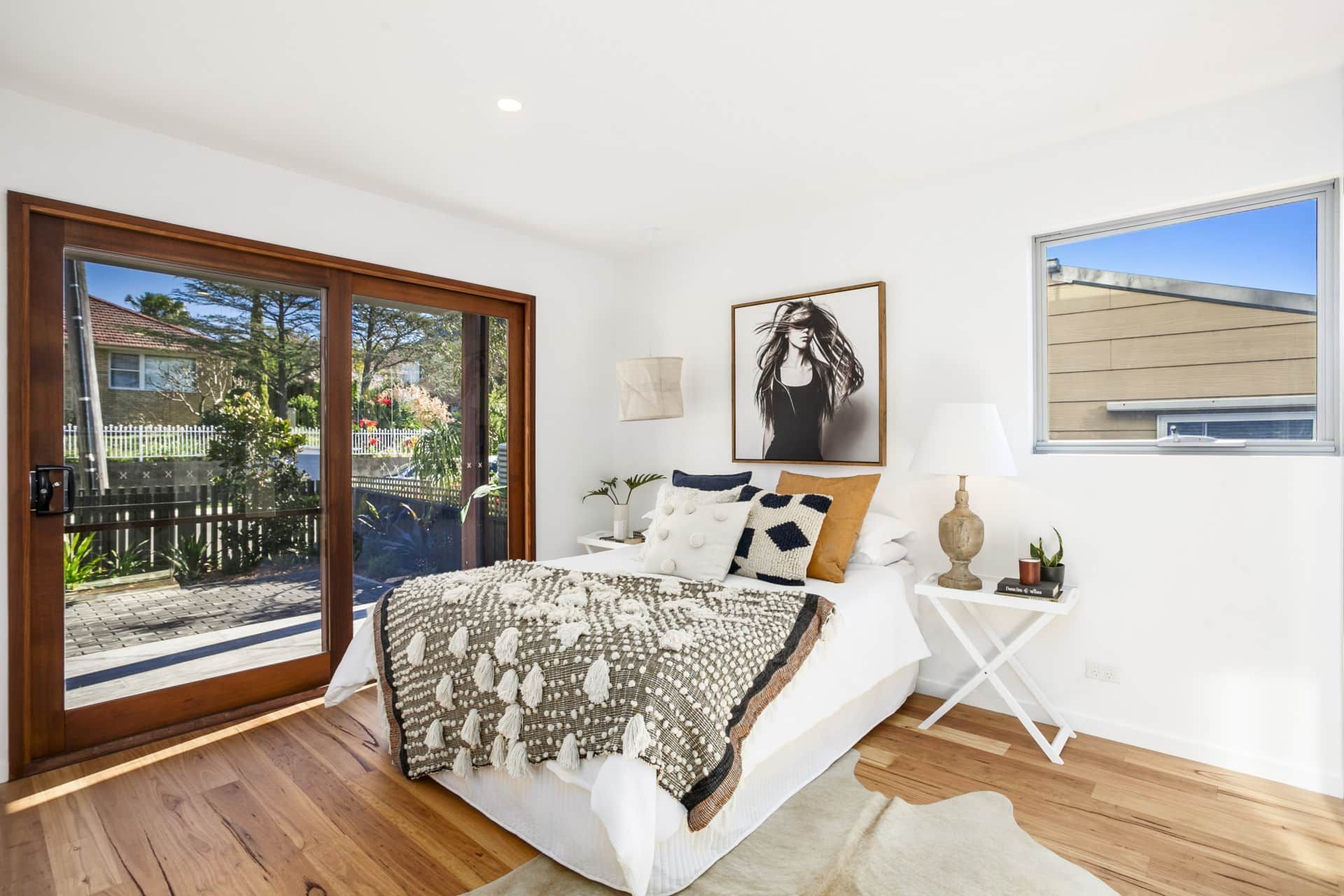 Bedroom With Hardwood Floors, Sliding Glass Door — Envisage Construction and Design in Keiraville, NSW