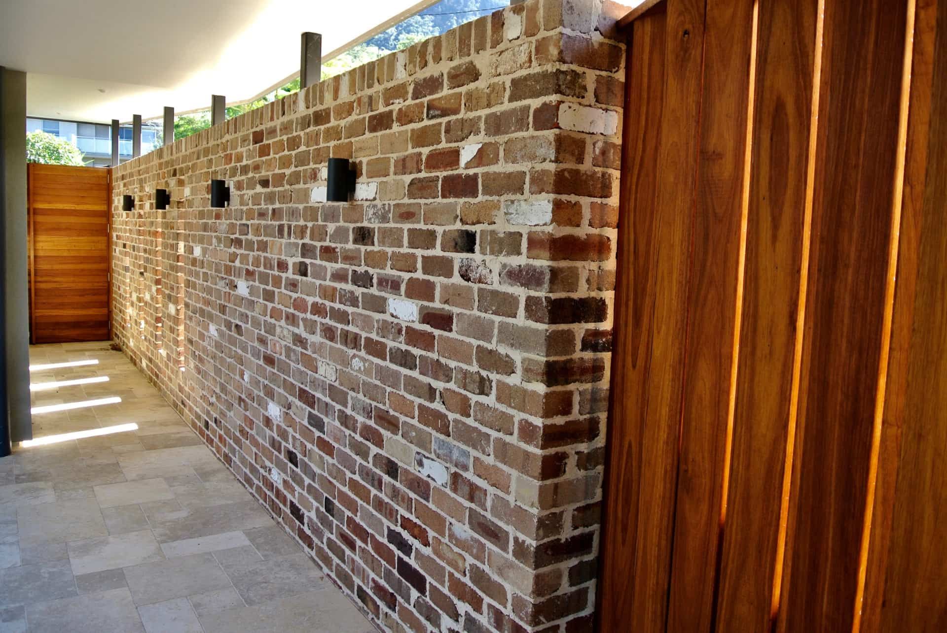 Brick Wall With Wood Panels and Stone Walkway — Envisage Construction and Design in Coledale, NS