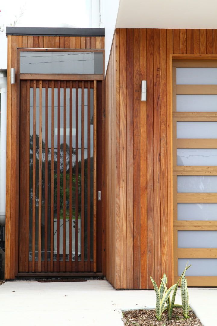 Wooden Front Door With Vertical Slats, Next to a Light-coloured Door — Envisage Construction and Design in Sydney, NSW