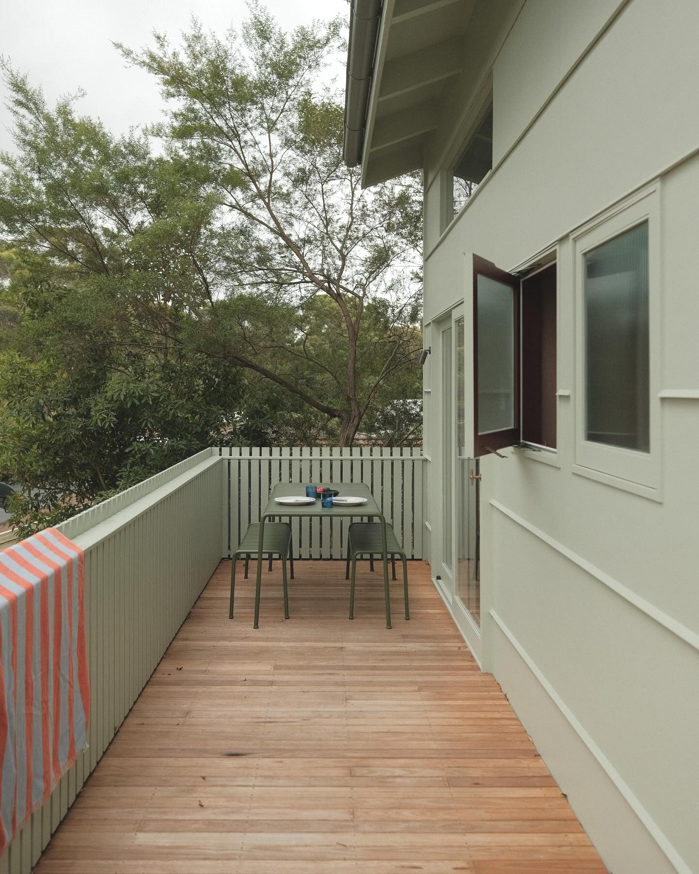 A Balcony With Wood Flooring, White Railing, Table, Chairs — Envisage Construction and Design in Mountain, NSW