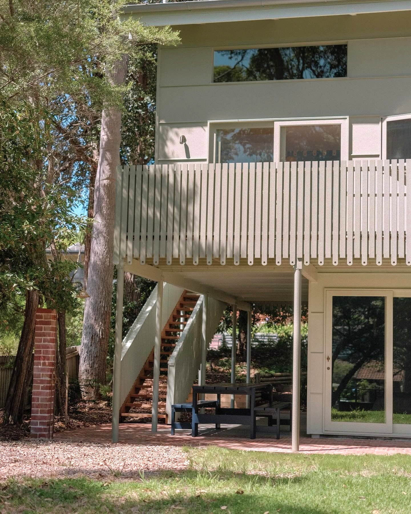 Two-Story House With a Balcony, Stairs, and a Small Table — Envisage Construction and Design in Mountain, NSW