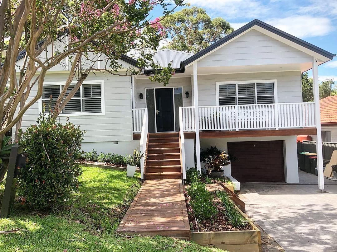 White House With Wooden Stairs Leading to the Front Door — Envisage Construction and Design in Mountain, NSW