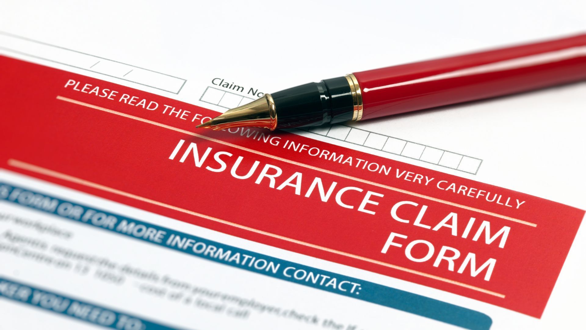 A pen is sitting on top of an insurance claim form.