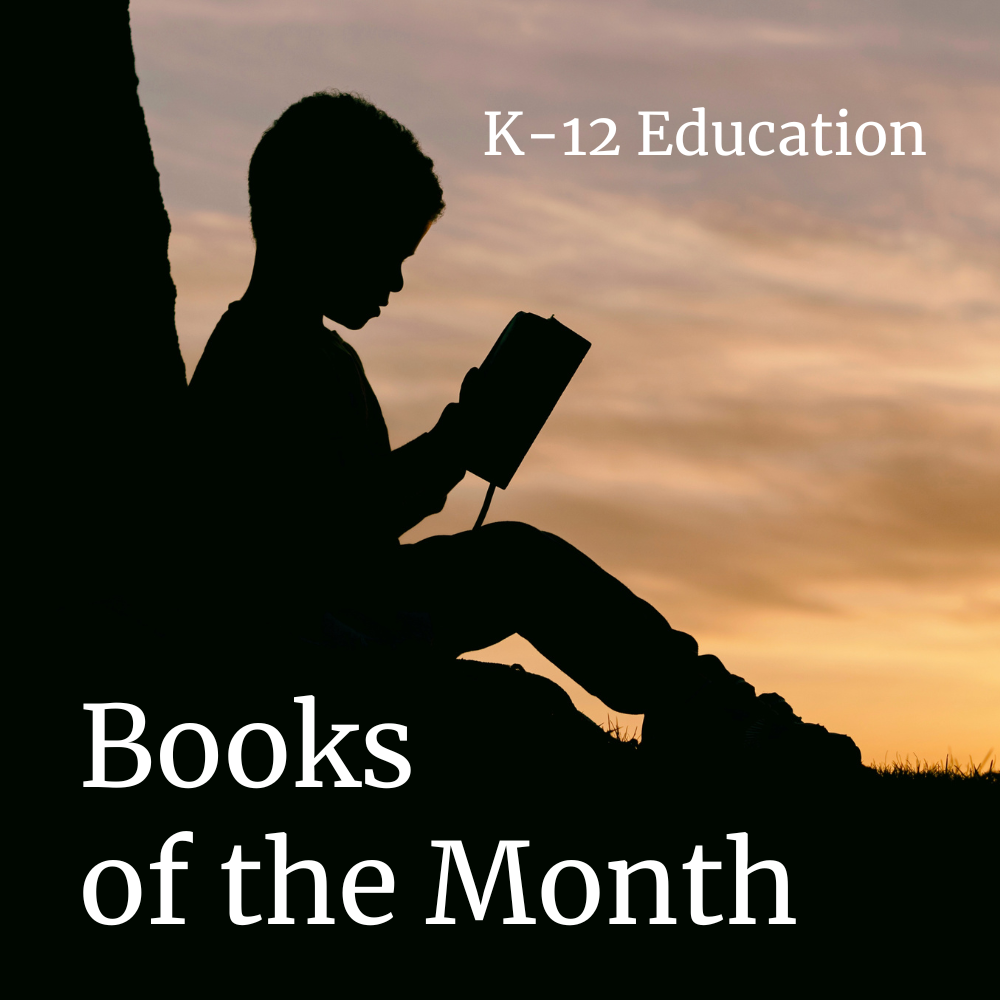 Silhouette of a child reading a book under a tree with a sunset background, titled 